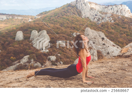 Woman doing yoga in mountains landscape Woman doing yoga in mountains landscape 25668667