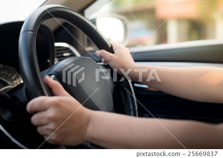 blurred woman driving a car 25669837