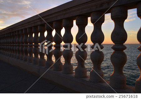 Balustrade with sunset in the sea behind Balustrade with sunset in the sea behind 25671618