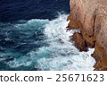 strong waves in blue sea splashing on rocks 25671623