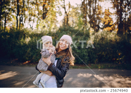 young family walking in the park 25674940