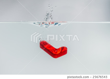 Red wooden alphabet L drop in the water Red wooden alphabet L drop in the water 25676543