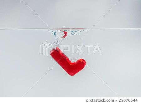 Red wooden alphabet L drop in the water Red wooden alphabet L drop in the water 25676544