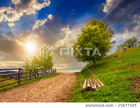fence on hillside meadow in mountain at sunset fence on hillside meadow in mountain at sunset 25677385