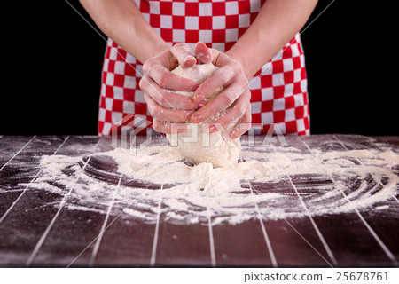 Cook preparing dough for baking in the kitchen 25678761