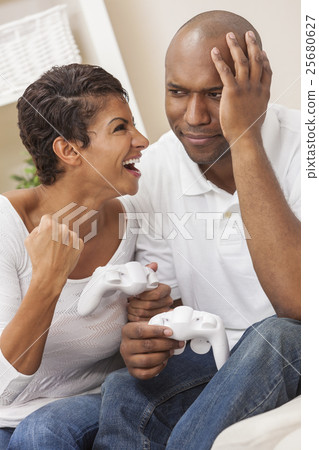 African American Couple Playing Video Console Game 25680627