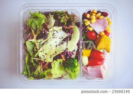 Fresh salad in packaging on white paper background 25688140