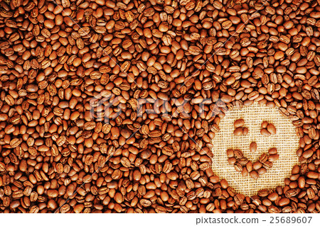 face coffee frame made of coffee beans on burlap texture  25689607
