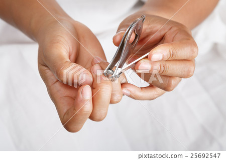 hand cutting fingernails 25692547