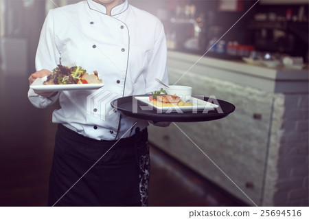 Waiters carrying plates with 25694516