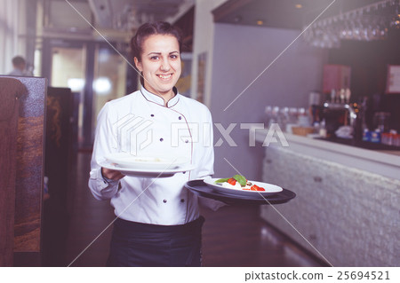 Waiters carrying plates with 25694521