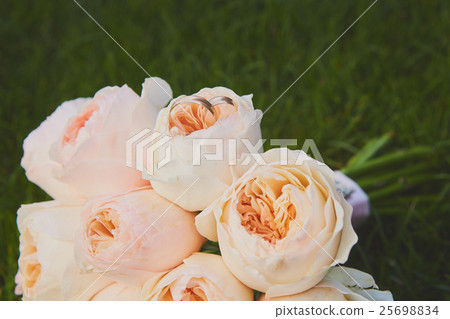 wedding bouquet of the bride at the grass. wedding bouquet of the bride at the grass. 25698834