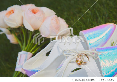 wedding bouquet and shoes lying down on green 25698839