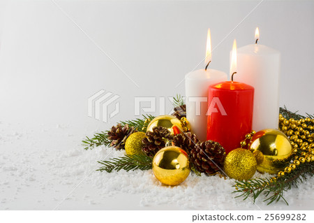 Burning candles in snow 25699282