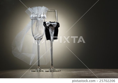 Two empty wineglass dressed in veil and wedding 25702206