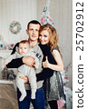 Christmas tree and happy family around 25702912
