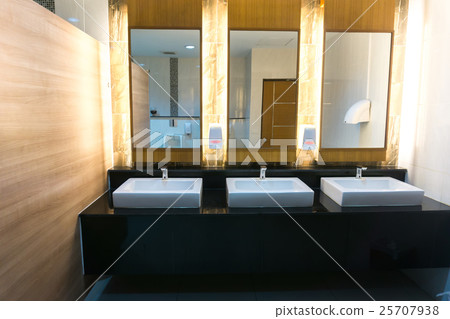 Commercial bathroom with three sink and mirror 25707938