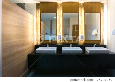 Commercial bathroom with three sink and mirror 25707939