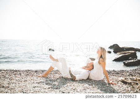 Fashion model couple with tattoo posing outside 25709623