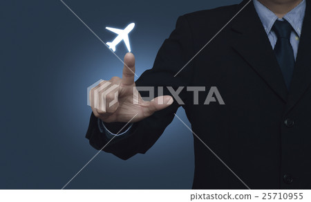 Businessman pressing airplane icon on blue Businessman pressing airplane icon on blue 25710955