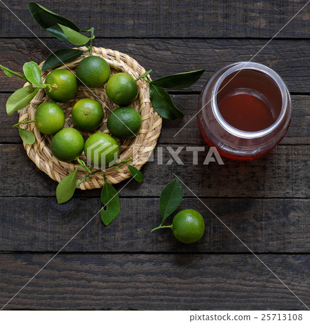 Green Kumquat fruit on wooden background Green Kumquat fruit on wooden background 25713108