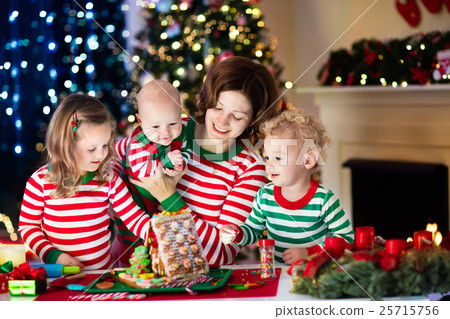 Family making ginger bread house on Christmas Family making ginger bread house on Christmas 25715756
