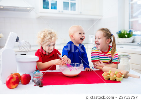 Kids baking a pie in white kitchen 25715757