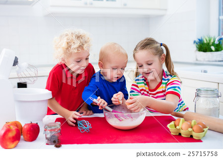 Kids baking a pie in white kitchen 25715758