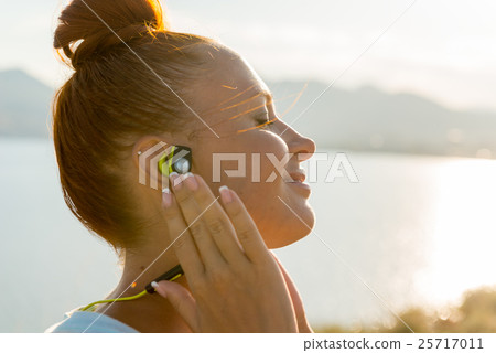 Fitness girl with wireless headphones 25717011