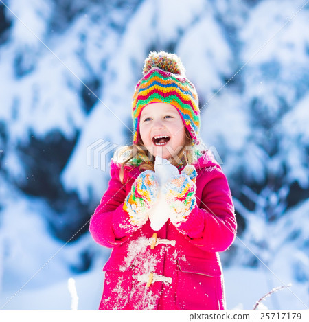 Child having fun in snowy winter park Child having fun in snowy winter park 25717179