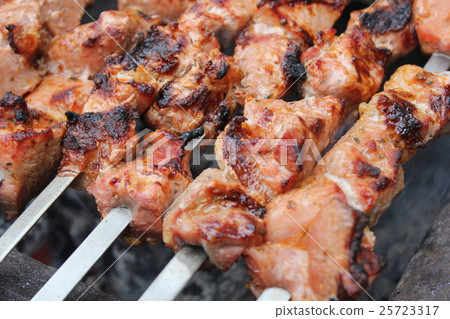 Meat porkis fried on the grill skewers at coals Meat porkis fried on the grill skewers at coals 25723317