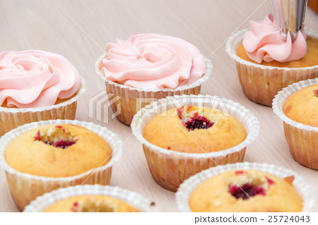 applying cream on cupcakes applying cream on cupcakes 25724043