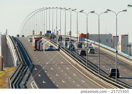 several trucks and cars driving on the highway several trucks and cars driving on the highway 25725303