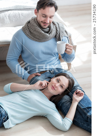 Handsome cheerful man looking at his girlfriend Handsome cheerful man looking at his girlfriend 25734190