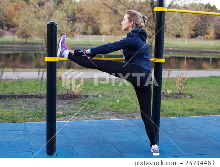 Young athletic woman stretching the leg Young athletic woman stretching the leg 25734461