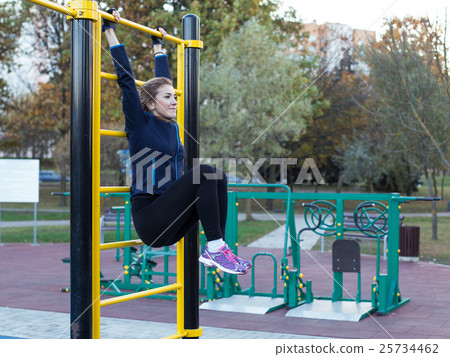 Young athletic woman doing leg rise Young athletic woman doing leg rise 25734462