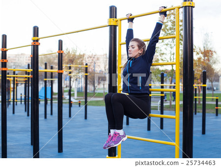 Young athletic woman doing leg rise 25734463