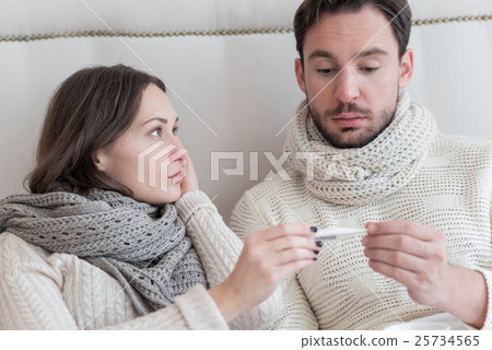 Beautiful ill woman showing her boyfriend a 25734565