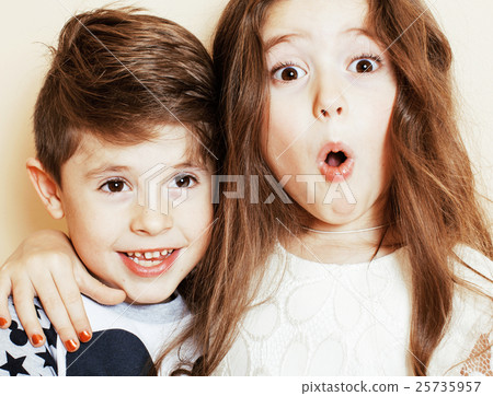 little cute boy and girl hugging playing on white 25735957