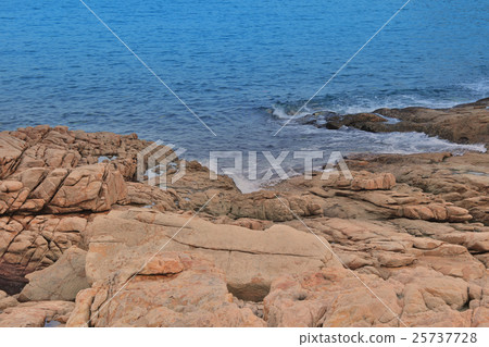 rocky sea coast and blurred water in shek o 25737728