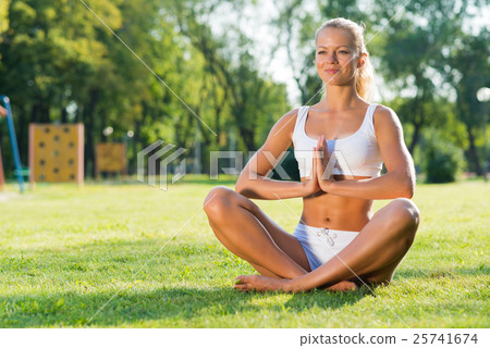 woman doing yoga in the park 25741674