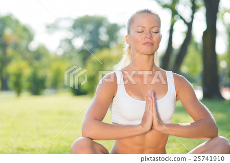 woman doing yoga in the park 25741910
