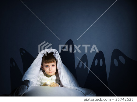 boy under the covers with a flashlight 25742525