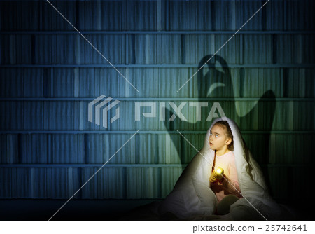 girl under the covers with a flashlight girl under the covers with a flashlight 25742641