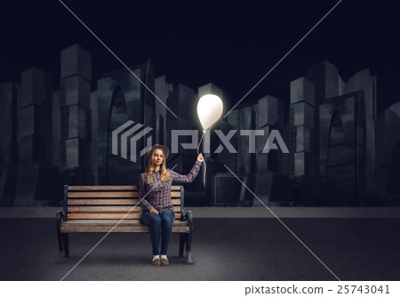 Young woman in casual holding balloon 25743041