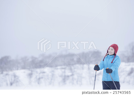 A woman taking a snowshoe A woman taking a snowshoe 25743565