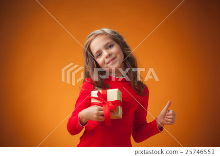 The cute cheerful little girl on orange background 25746551