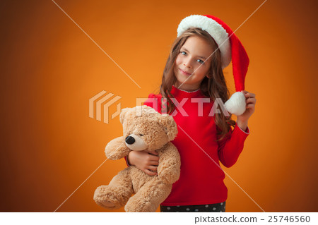 The cute cheerful little girl on orange background The cute cheerful little girl on orange background 25746560