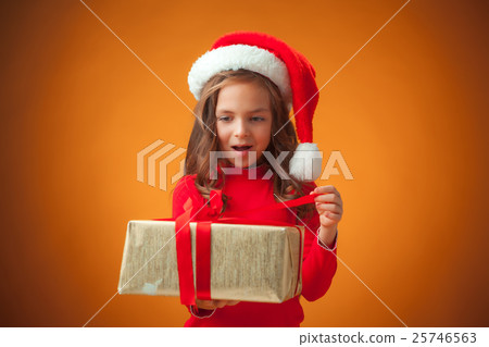 The cute cheerful little girl on orange background 25746563