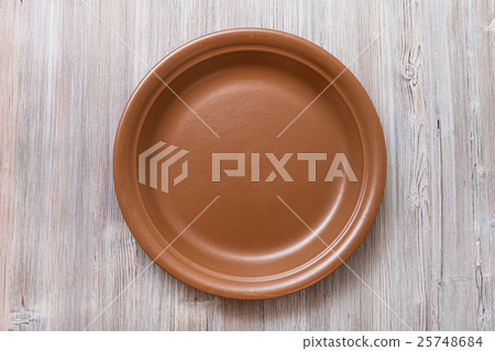 above view of brown plate on gray brown table above view of brown plate on gray brown table 25748684